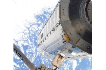 The Kibo Japanese Pressurized Module in the grasp of the robotic Canadarm2.